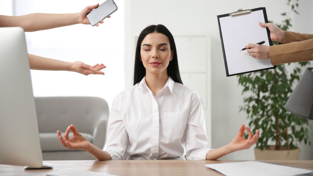 woman meditating at work for work-life balance